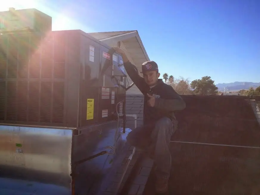 HVAC technician performing Air Duct Cleaning on a rooftop unit in Cahokia Heights